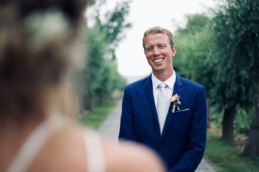 shallow focus photo of man in blue suit jacket